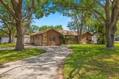 This spacious home with circle drive and fenced yard has plenty on Pinecrest Golf Club in Florida - for sale on GolfHomes.com, golf home, golf lot