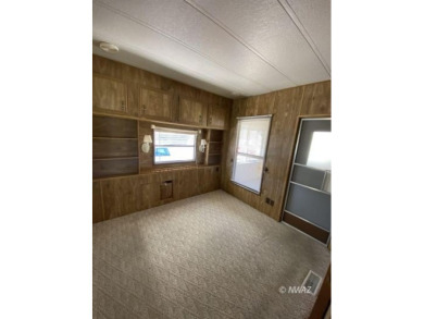 This manufactured home in Beaver Dam Resorts is an inviting on Beaver Dam Resort in Arizona - for sale on GolfHomes.com, golf home, golf lot