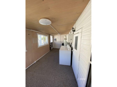 This manufactured home in Beaver Dam Resorts is an inviting on Beaver Dam Resort in Arizona - for sale on GolfHomes.com, golf home, golf lot