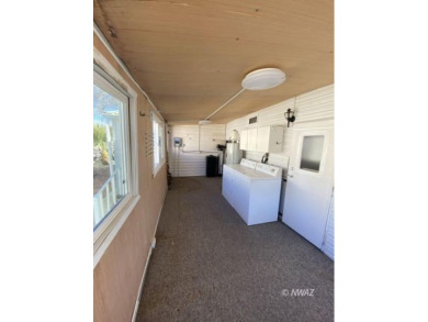 This manufactured home in Beaver Dam Resorts is an inviting on Beaver Dam Resort in Arizona - for sale on GolfHomes.com, golf home, golf lot