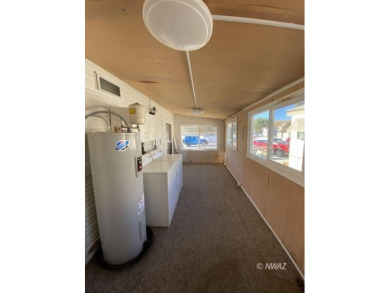 This manufactured home in Beaver Dam Resorts is an inviting on Beaver Dam Resort in Arizona - for sale on GolfHomes.com, golf home, golf lot