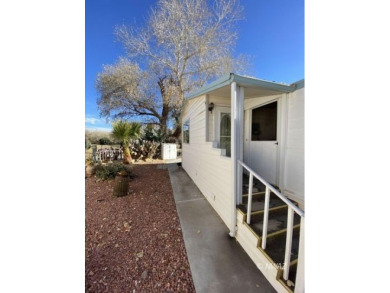 This manufactured home in Beaver Dam Resorts is an inviting on Beaver Dam Resort in Arizona - for sale on GolfHomes.com, golf home, golf lot