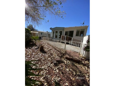 This manufactured home in Beaver Dam Resorts is an inviting on Beaver Dam Resort in Arizona - for sale on GolfHomes.com, golf home, golf lot