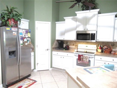 A 2/3 bedroom, 2 bath villa with wonderful lake views and a on Sabal Trace Golf and Country Club in Florida - for sale on GolfHomes.com, golf home, golf lot