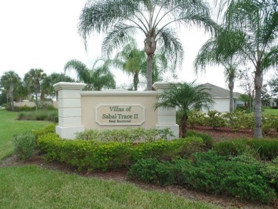 A 2/3 bedroom, 2 bath villa with wonderful lake views and a on Sabal Trace Golf and Country Club in Florida - for sale on GolfHomes.com, golf home, golf lot