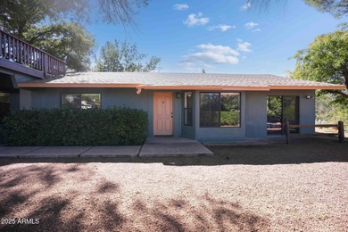 Charming house nestled among mature trees on a quiet street on Canyon Mesa Country Club in Arizona - for sale on GolfHomes.com, golf home, golf lot