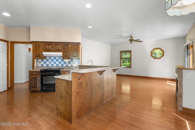 Welcome home to this cozy custom-built ranch nestled in the on Sound Golf Links at Albemarle Plantation in North Carolina - for sale on GolfHomes.com, golf home, golf lot