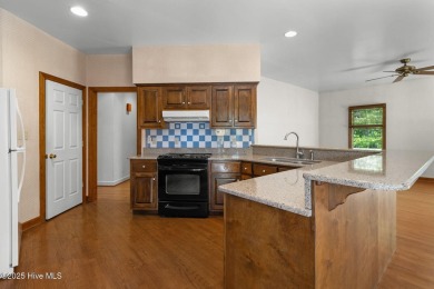 Welcome home to this cozy custom-built ranch nestled in the on Sound Golf Links at Albemarle Plantation in North Carolina - for sale on GolfHomes.com, golf home, golf lot