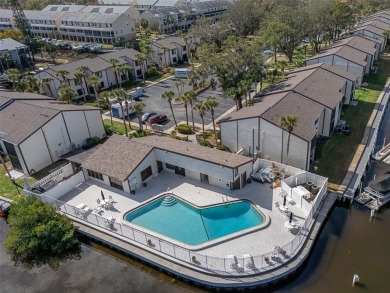 Embrace quintessential Florida waterfront living in this on Tarpon Springs Golf Course in Florida - for sale on GolfHomes.com, golf home, golf lot
