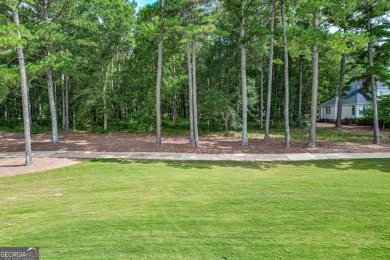 Located in the prestigious Great Waters neighborhood of Reynolds on Great Waters Course At Reynolds Plantation in Georgia - for sale on GolfHomes.com, golf home, golf lot