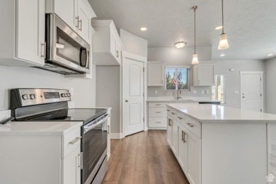 Enjoy laminate floors, an open kitchen with quartz counters on The Ranches Golf Club in Utah - for sale on GolfHomes.com, golf home, golf lot