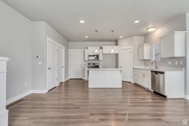 Enjoy laminate floors, an open kitchen with quartz counters on The Ranches Golf Club in Utah - for sale on GolfHomes.com, golf home, golf lot
