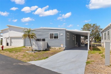 Show stopper! This totally remodeled rare 3 bedroom/2 bath on Mangrove Bay Golf Course in Florida - for sale on GolfHomes.com, golf home, golf lot