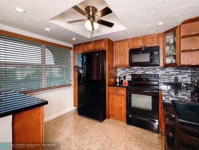 ALL IMPACT WINDOWS, PATIO  FRONT DOOR. OPEN KITCHEN REAL WOOD on Wynmoor Golf Course in Florida - for sale on GolfHomes.com, golf home, golf lot