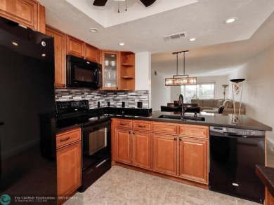 ALL IMPACT WINDOWS, PATIO  FRONT DOOR. OPEN KITCHEN REAL WOOD on Wynmoor Golf Course in Florida - for sale on GolfHomes.com, golf home, golf lot