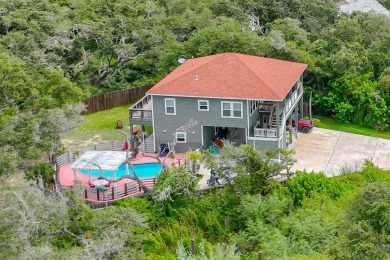 Check out this amazing home nestled in between two wooded lots on Rockport Country Club in Texas - for sale on GolfHomes.com, golf home, golf lot