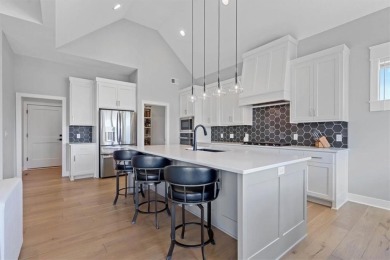 This 4-bedroom, 4-bath reverse 1.5-story is packed with upgrades on Heritage Park Golf Course in Kansas - for sale on GolfHomes.com, golf home, golf lot