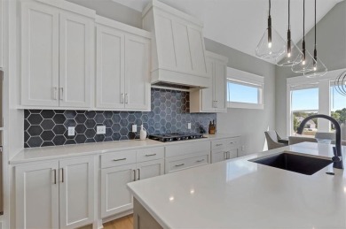 This 4-bedroom, 4-bath reverse 1.5-story is packed with upgrades on Heritage Park Golf Course in Kansas - for sale on GolfHomes.com, golf home, golf lot