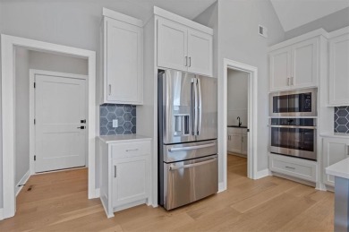 This 4-bedroom, 4-bath reverse 1.5-story is packed with upgrades on Heritage Park Golf Course in Kansas - for sale on GolfHomes.com, golf home, golf lot