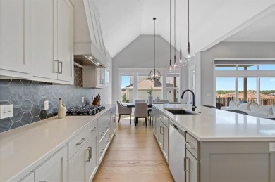 This 4-bedroom, 4-bath reverse 1.5-story is packed with upgrades on Heritage Park Golf Course in Kansas - for sale on GolfHomes.com, golf home, golf lot