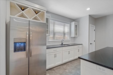 This 4-bedroom, 4-bath reverse 1.5-story is packed with upgrades on Heritage Park Golf Course in Kansas - for sale on GolfHomes.com, golf home, golf lot