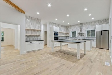 This stunning new construction blends luxury, functionality, and on The Highlands Course at Lake Arrowhead in Georgia - for sale on GolfHomes.com, golf home, golf lot