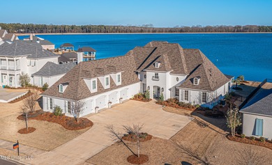 Poised along the water's edge in the prestigious Reunion Golf on Reunion Golf Club in Mississippi - for sale on GolfHomes.com, golf home, golf lot