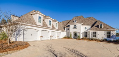 Poised along the water's edge in the prestigious Reunion Golf on Reunion Golf Club in Mississippi - for sale on GolfHomes.com, golf home, golf lot