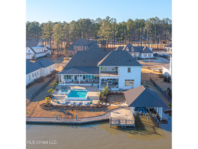 Poised along the water's edge in the prestigious Reunion Golf on Reunion Golf Club in Mississippi - for sale on GolfHomes.com, golf home, golf lot