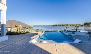 Poised along the water's edge in the prestigious Reunion Golf on Reunion Golf Club in Mississippi - for sale on GolfHomes.com, golf home, golf lot