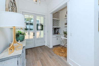 Poised along the water's edge in the prestigious Reunion Golf on Reunion Golf Club in Mississippi - for sale on GolfHomes.com, golf home, golf lot