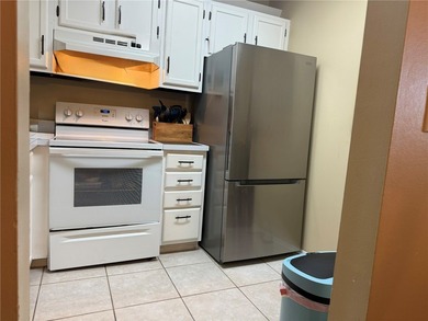 1ST FLOOR condo overlooking the fairway from the living room on The American Golf Club in Florida - for sale on GolfHomes.com, golf home, golf lot