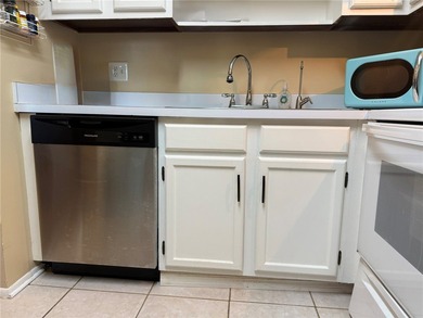 1ST FLOOR condo overlooking the fairway from the living room on The American Golf Club in Florida - for sale on GolfHomes.com, golf home, golf lot