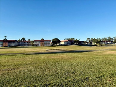 1ST FLOOR condo overlooking the fairway from the living room on The American Golf Club in Florida - for sale on GolfHomes.com, golf home, golf lot