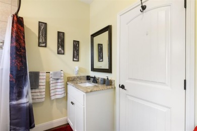 This beautifully designed stone home with blue and red accents on Lighthouse Golf Course in Texas - for sale on GolfHomes.com, golf home, golf lot