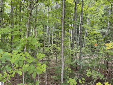 This 1.12-acre parcel features mature hardwoods and a gentle on Manitou Passage Golf Club in Michigan - for sale on GolfHomes.com, golf home, golf lot