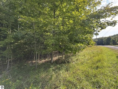 This 1.12-acre parcel features mature hardwoods and a gentle on Manitou Passage Golf Club in Michigan - for sale on GolfHomes.com, golf home, golf lot