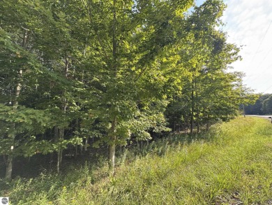 This 1.12-acre parcel features mature hardwoods and a gentle on Manitou Passage Golf Club in Michigan - for sale on GolfHomes.com, golf home, golf lot