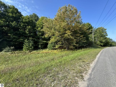 This 0.81-acre parcel features mature hardwoods, open area near on Manitou Passage Golf Club in Michigan - for sale on GolfHomes.com, golf home, golf lot