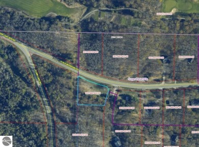 This 0.81-acre parcel features mature hardwoods, open area near on Manitou Passage Golf Club in Michigan - for sale on GolfHomes.com, golf home, golf lot