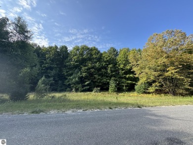 This 0.81-acre parcel features mature hardwoods, open area near on Manitou Passage Golf Club in Michigan - for sale on GolfHomes.com, golf home, golf lot