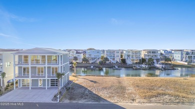 Situated in a private gated community overlooking one of Sunset on Oyster Bay Golf Links in North Carolina - for sale on GolfHomes.com, golf home, golf lot