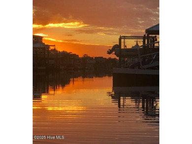 Situated in a private gated community overlooking one of Sunset on Oyster Bay Golf Links in North Carolina - for sale on GolfHomes.com, golf home, golf lot