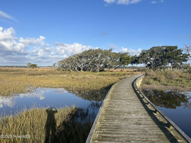 Situated in a private gated community overlooking one of Sunset on Oyster Bay Golf Links in North Carolina - for sale on GolfHomes.com, golf home, golf lot