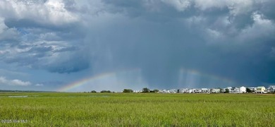 Situated in a private gated community overlooking one of Sunset on Oyster Bay Golf Links in North Carolina - for sale on GolfHomes.com, golf home, golf lot
