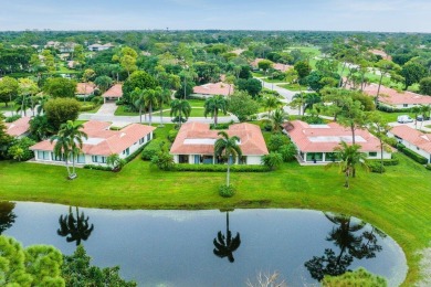 Nestled within lush landscaping and peaceful water views, this on Quail Ridge Golf Course and Country Club in Florida - for sale on GolfHomes.com, golf home, golf lot