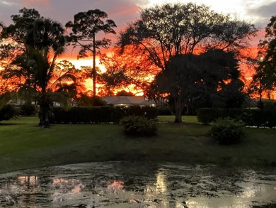 Nestled within lush landscaping and peaceful water views, this on Quail Ridge Golf Course and Country Club in Florida - for sale on GolfHomes.com, golf home, golf lot