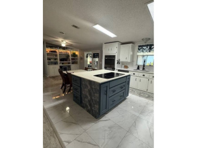 Indulge in expansive living within this magnificent double-wide on Hamptons Golf Club in Florida - for sale on GolfHomes.com, golf home, golf lot