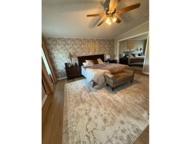 Indulge in expansive living within this magnificent double-wide on Hamptons Golf Club in Florida - for sale on GolfHomes.com, golf home, golf lot