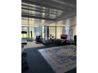 Indulge in expansive living within this magnificent double-wide on Hamptons Golf Club in Florida - for sale on GolfHomes.com, golf home, golf lot